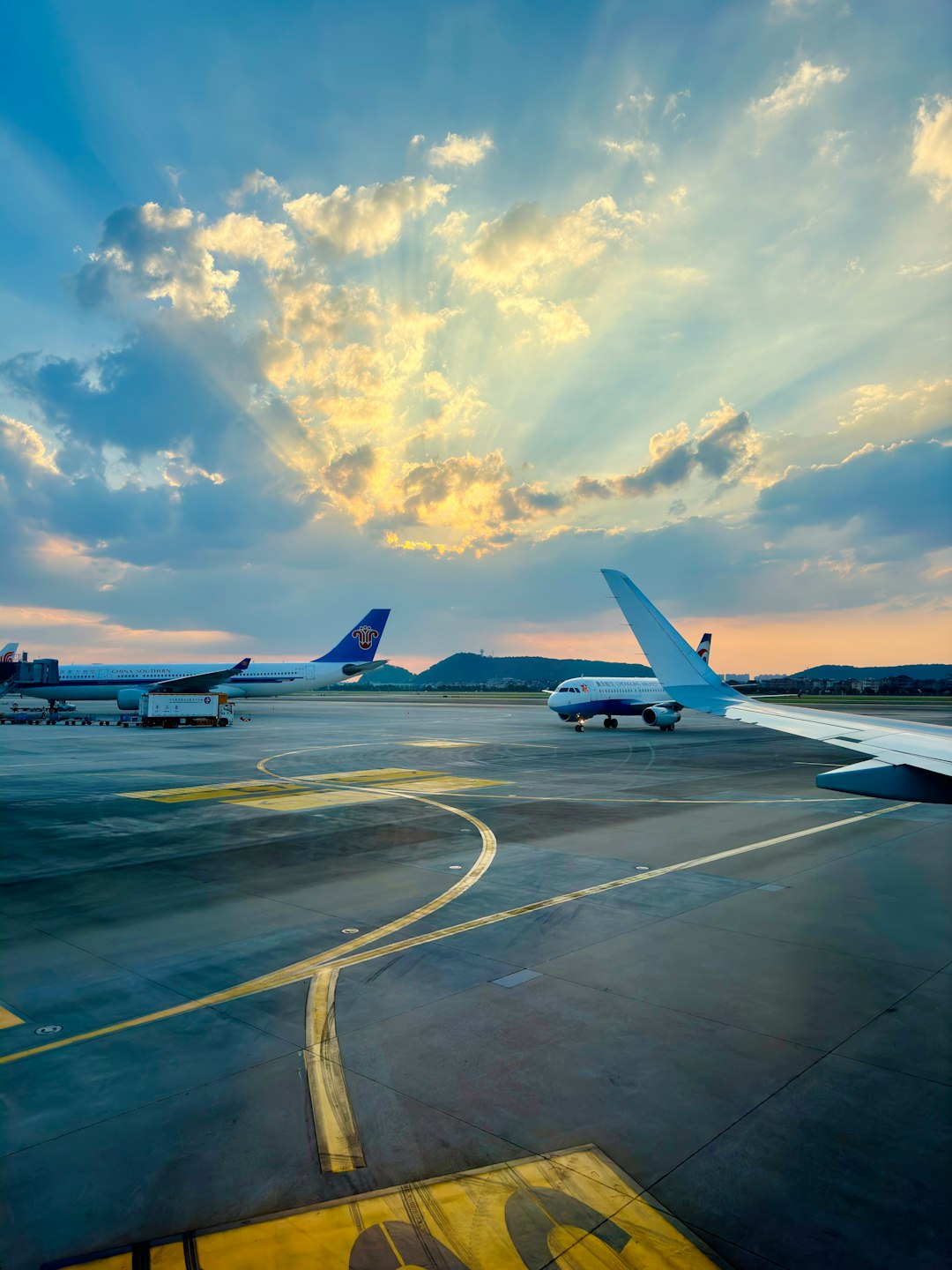 Airplanes on Runway with Stunning Sunset Rays